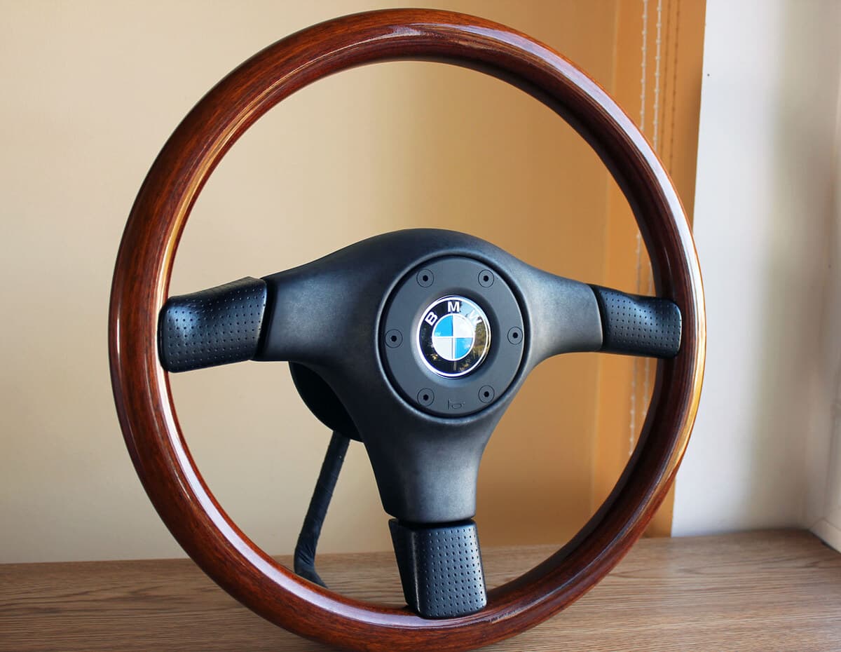 Nardi BMW Woodline steering wheel — wood rim, perforated leather spokes, BMW roundel, KBA 70175