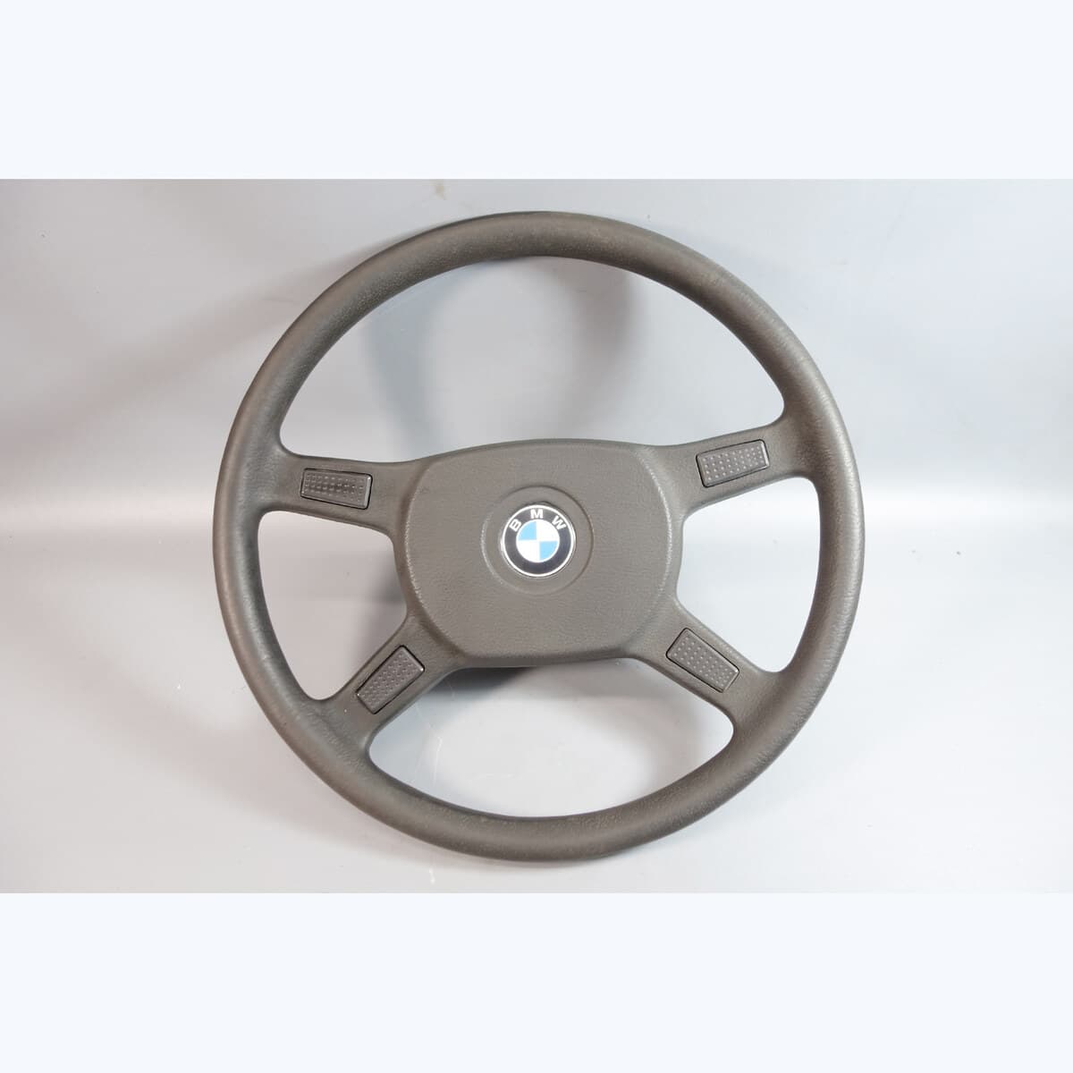 BMW E30 standard 4-spoke steering wheel with round centre pad and roundel plaque